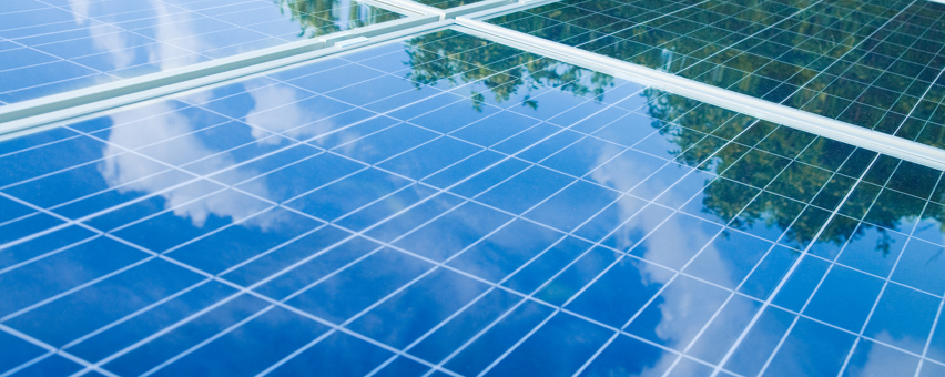 Solar Panels showing reflection of the sky with clouds